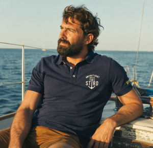 Homme portant un polo marin STERED sur un voilier